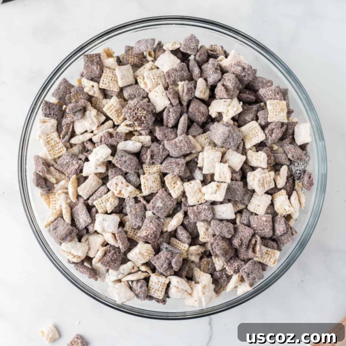 Cookies and Cream Dream Bites 14 A close-up of the delicious Cookies and Cream Muddy Buddies, showing the variety of coated Chex pieces and crushed Oreos mixed together.