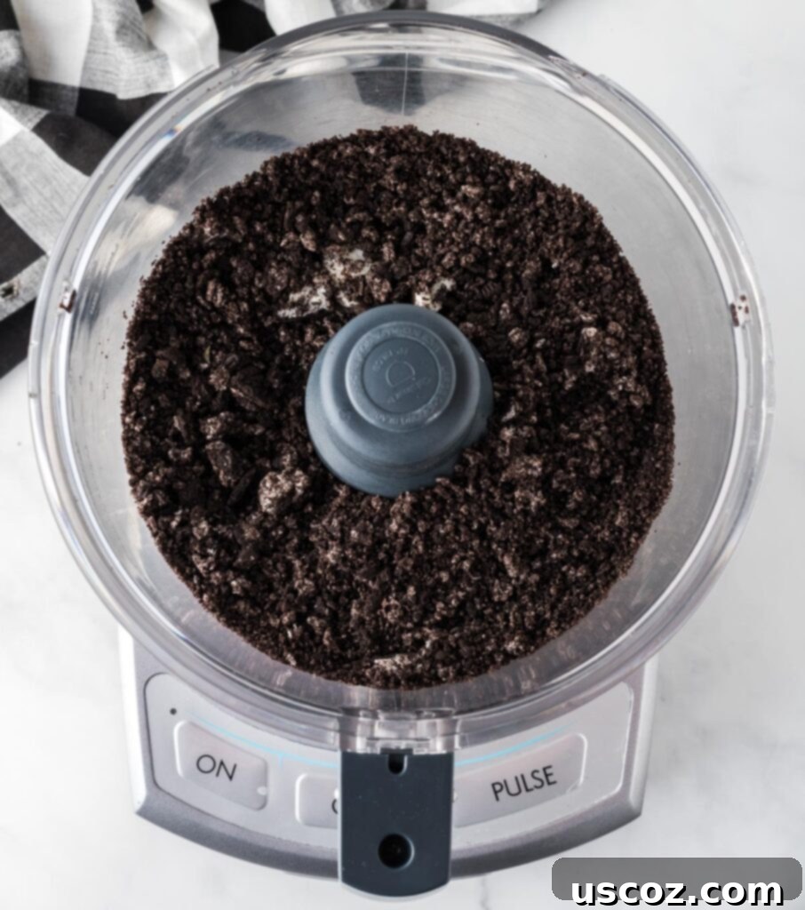 Cookies and Cream Dream Bites 6 Finely ground Oreo cookie dust inside a food processor, perfectly crushed for the muddy buddies recipe.