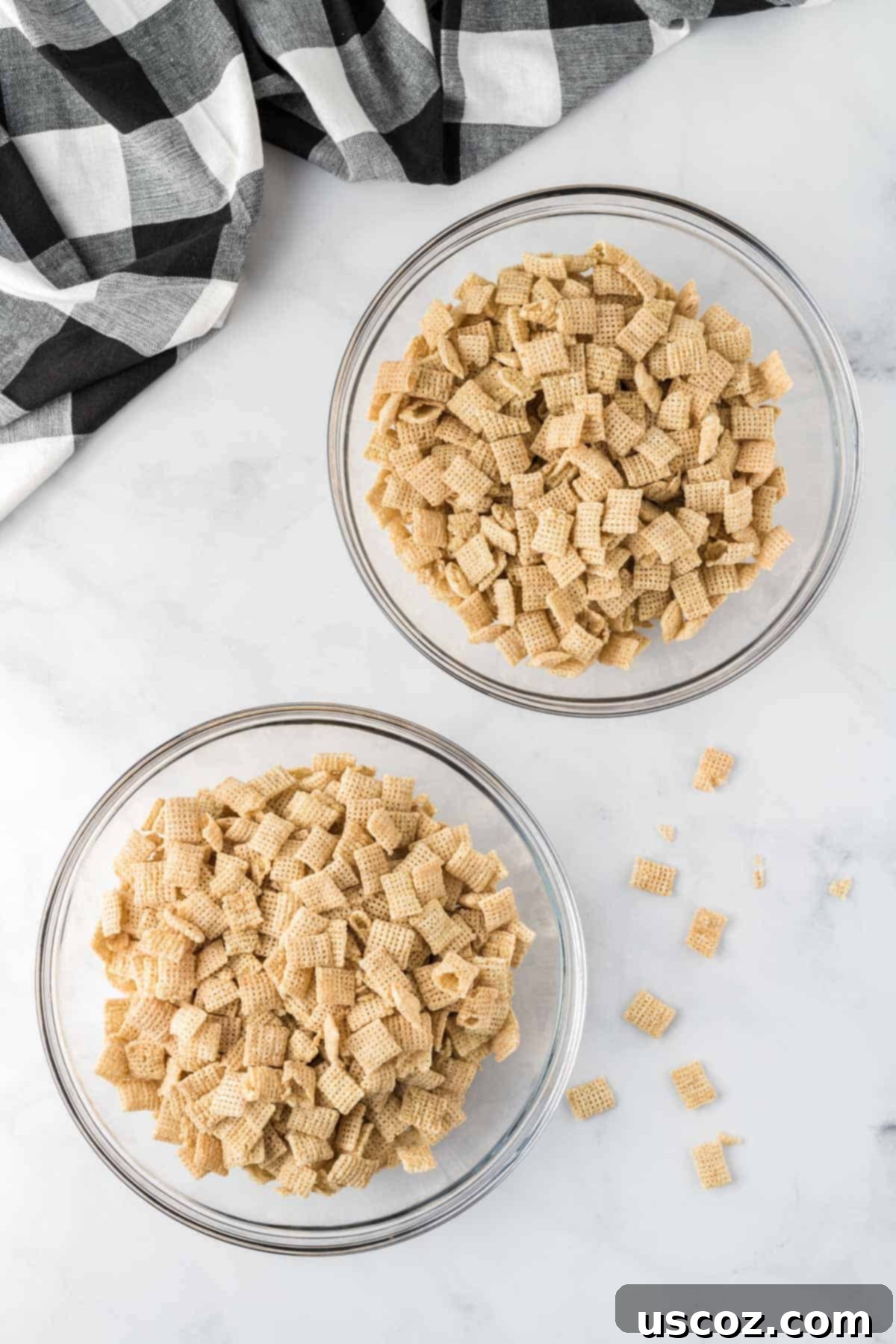 Cookies and Cream Dream Bites 7 Two separate bowls, each filled with precisely 4 cups of crisp Rice Chex cereal, ready for coating.