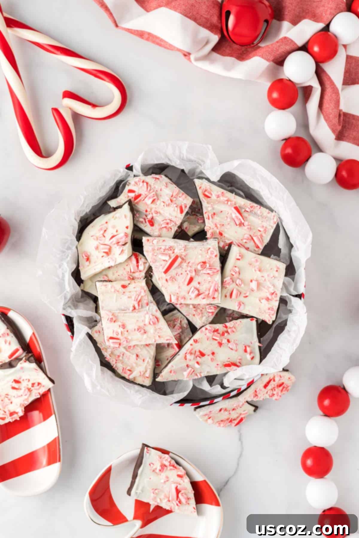 Decadent Mint Chocolate Bark 16 Chocolate peppermint bark neatly arranged in a festive candy tin, highlighting its appeal as a homemade Christmas gift.