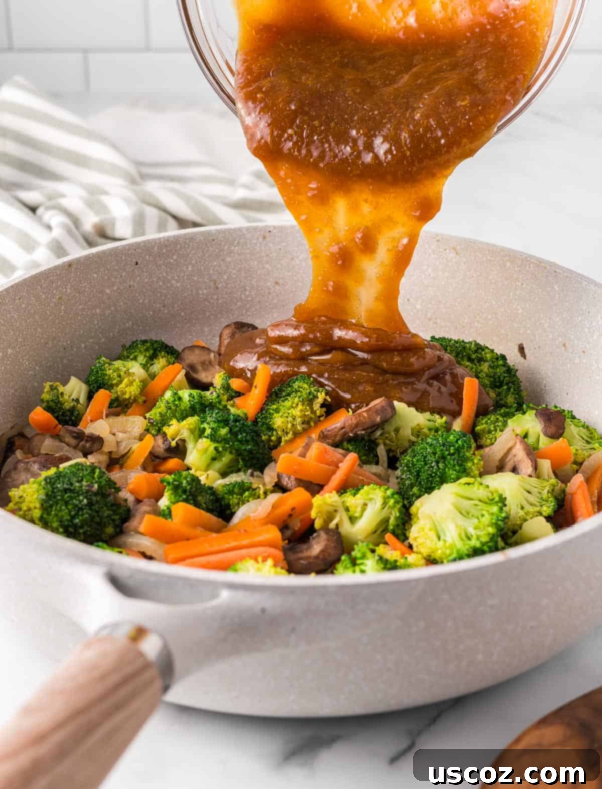 Sizzling Teriyaki Harvest 7 pouring the teriyaki sauce over the vegetables