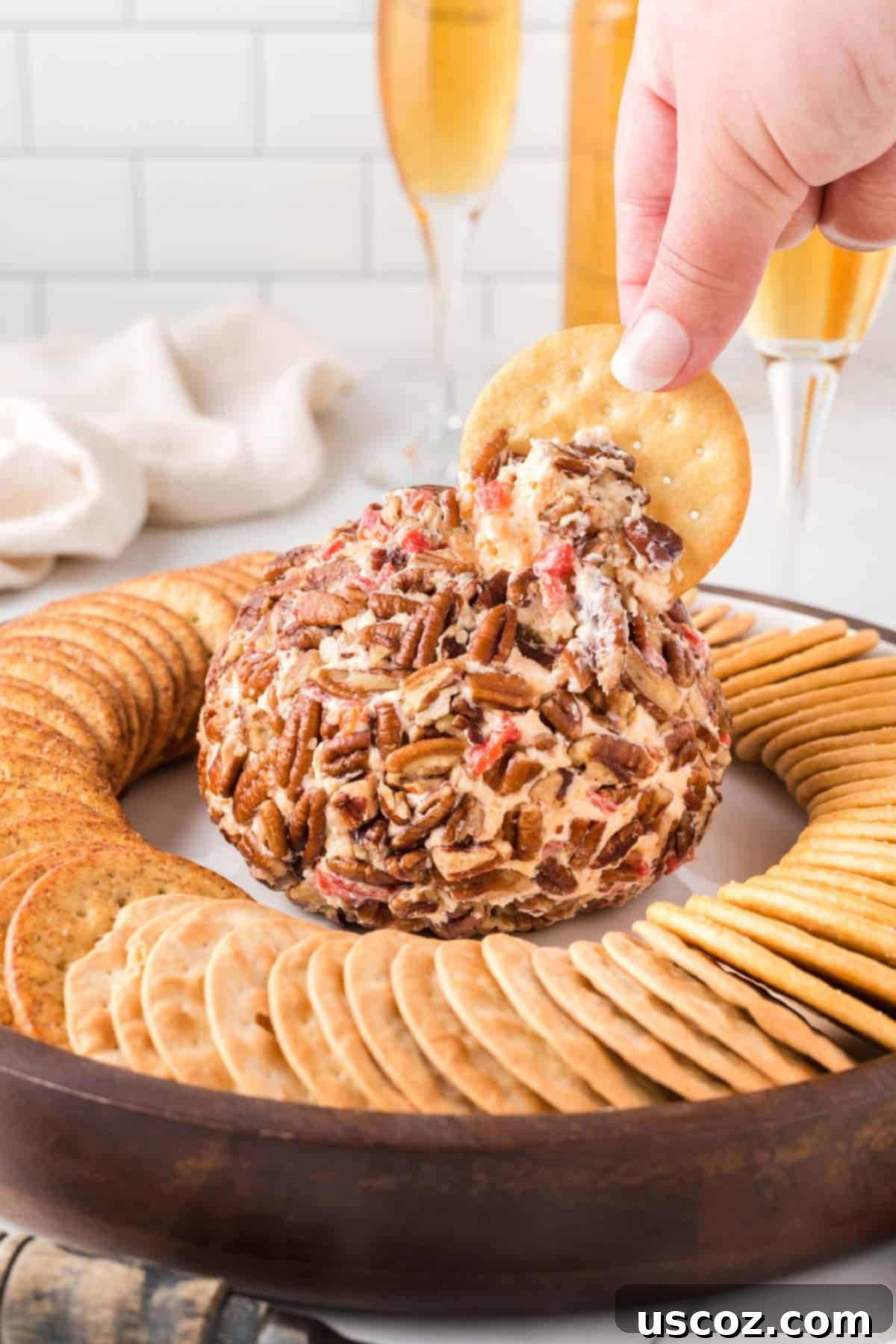 Classic Pimento Cheese Ball 2 cracker dipping into a cheese ball