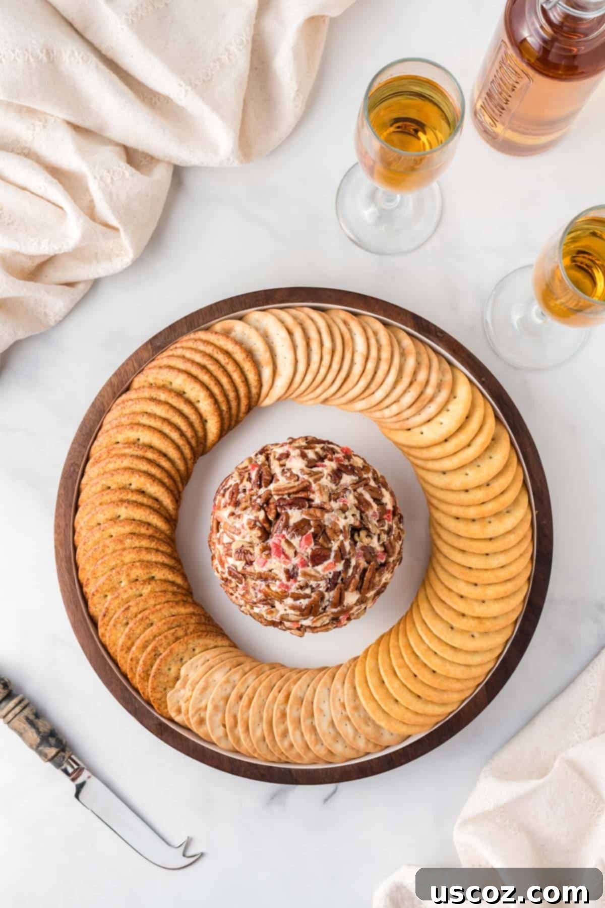 Classic Pimento Cheese Ball 13 pimento cheese ball on a platter surrounded by crackers