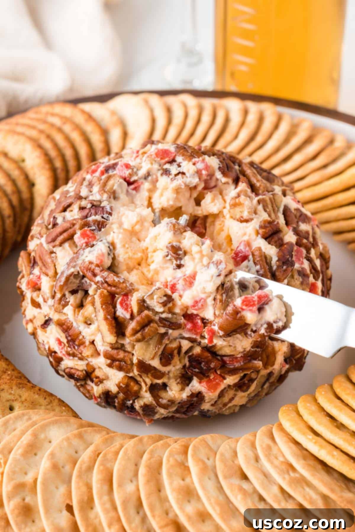 Classic Pimento Cheese Ball 3 serving knife in the cheese ball