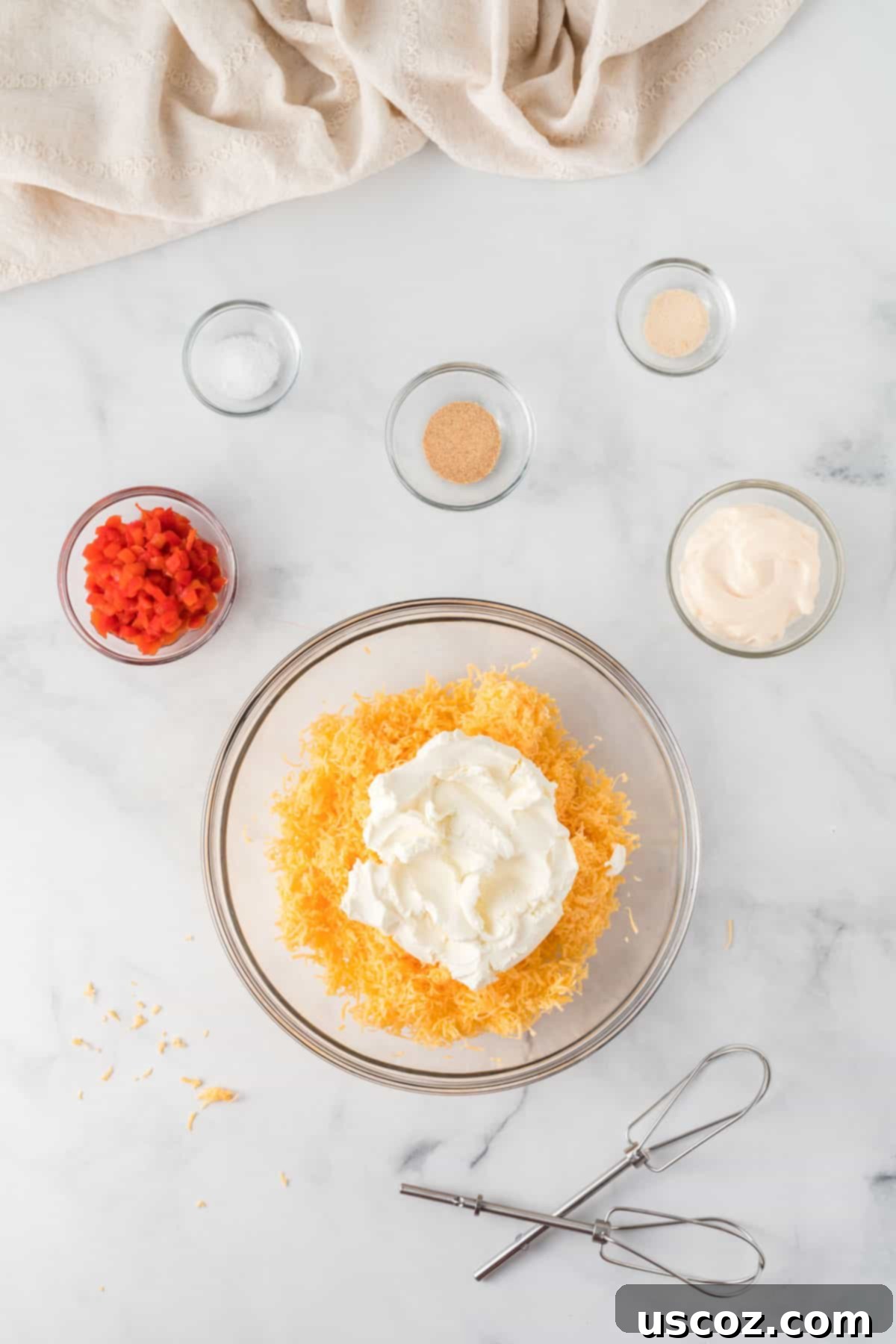 Classic Pimento Cheese Ball 6 cream cheese and cheddar in a bowl surrounded by the other ingredients