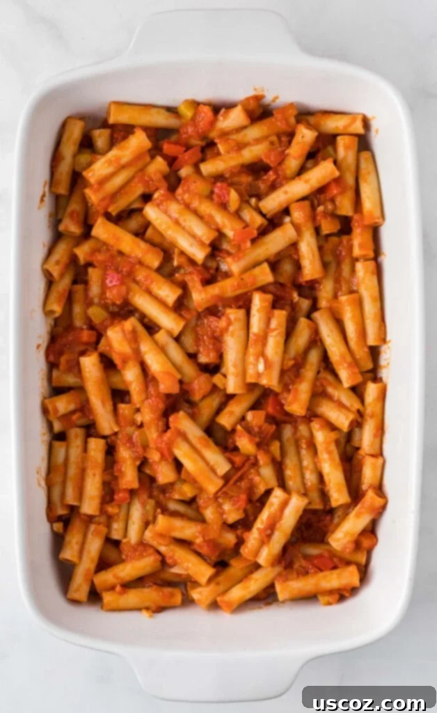 Cheesy Meatless Ziti Bake 13 First layer of ziti noodles and sauce in a white casserole dish