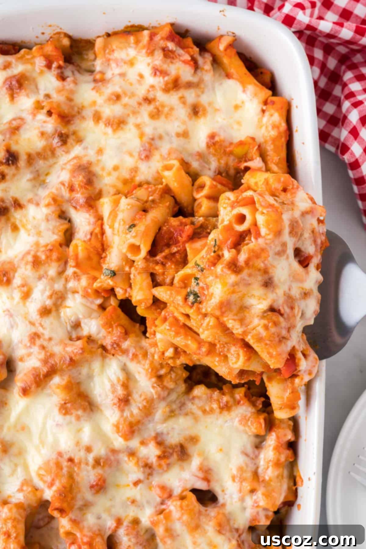 Cheesy Meatless Ziti Bake 18 A serving of vegetarian baked ziti being lifted from the casserole dish, revealing gooey cheese and pasta
