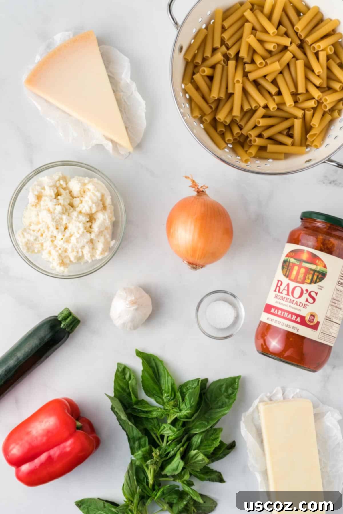 Cheesy Meatless Ziti Bake 3 Fresh ingredients like bell pepper, onion, zucchini, and basil laid out for vegetarian baked ziti