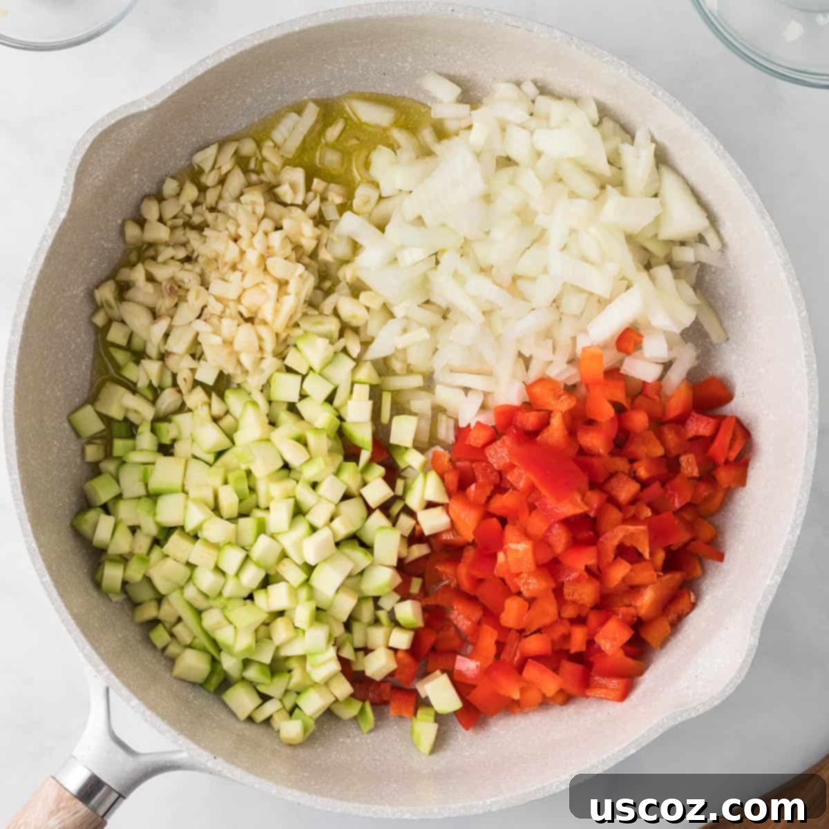 Cheesy Meatless Ziti Bake 5 Adding bell pepper, onion, garlic, and zucchini to the skillet for sautéing