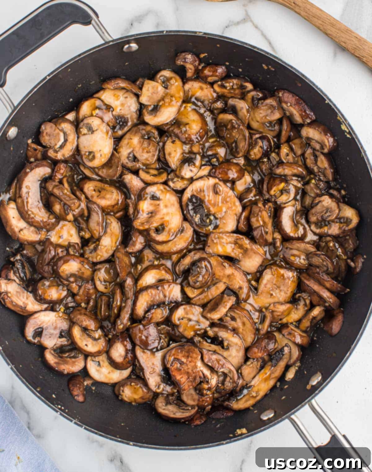 Glazed Teriyaki Mushrooms 2 Sizzling pan-fried teriyaki mushrooms in a black skillet, ready to serve.