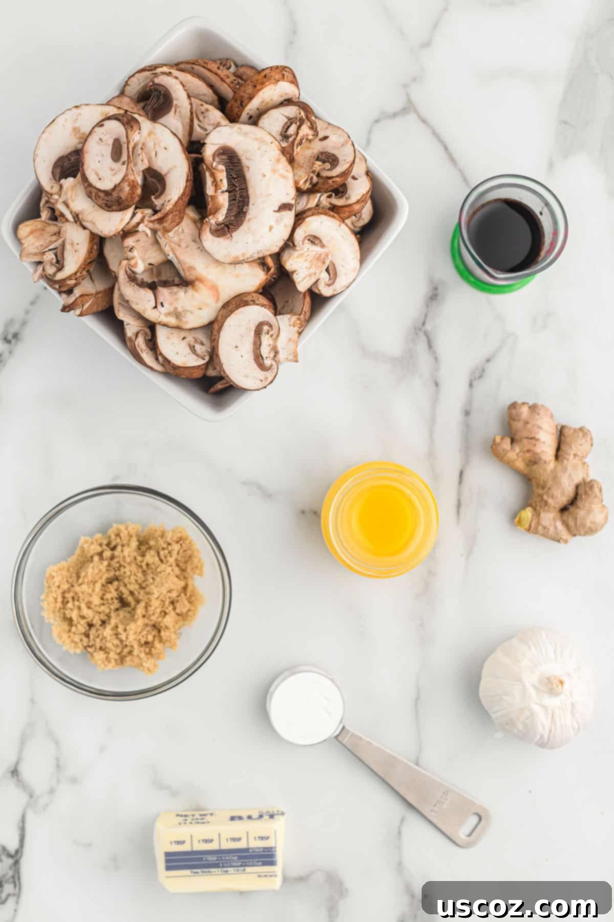 Glazed Teriyaki Mushrooms 3 All the fresh ingredients laid out on a cutting board, including sliced mushrooms, garlic, and components for homemade teriyaki sauce.