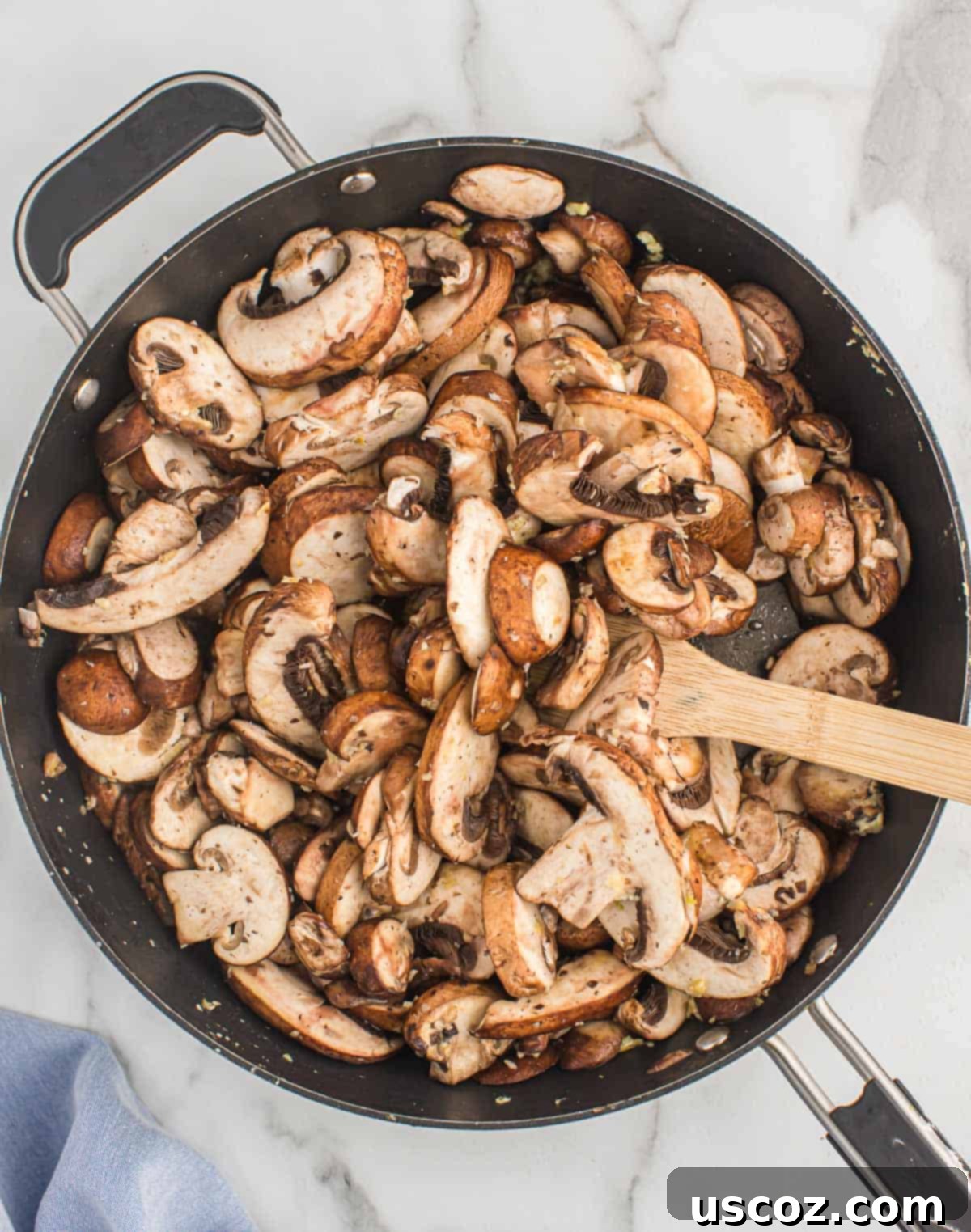 Glazed Teriyaki Mushrooms 4 Adding fresh sliced mushrooms to a hot skillet with melted butter and minced garlic.