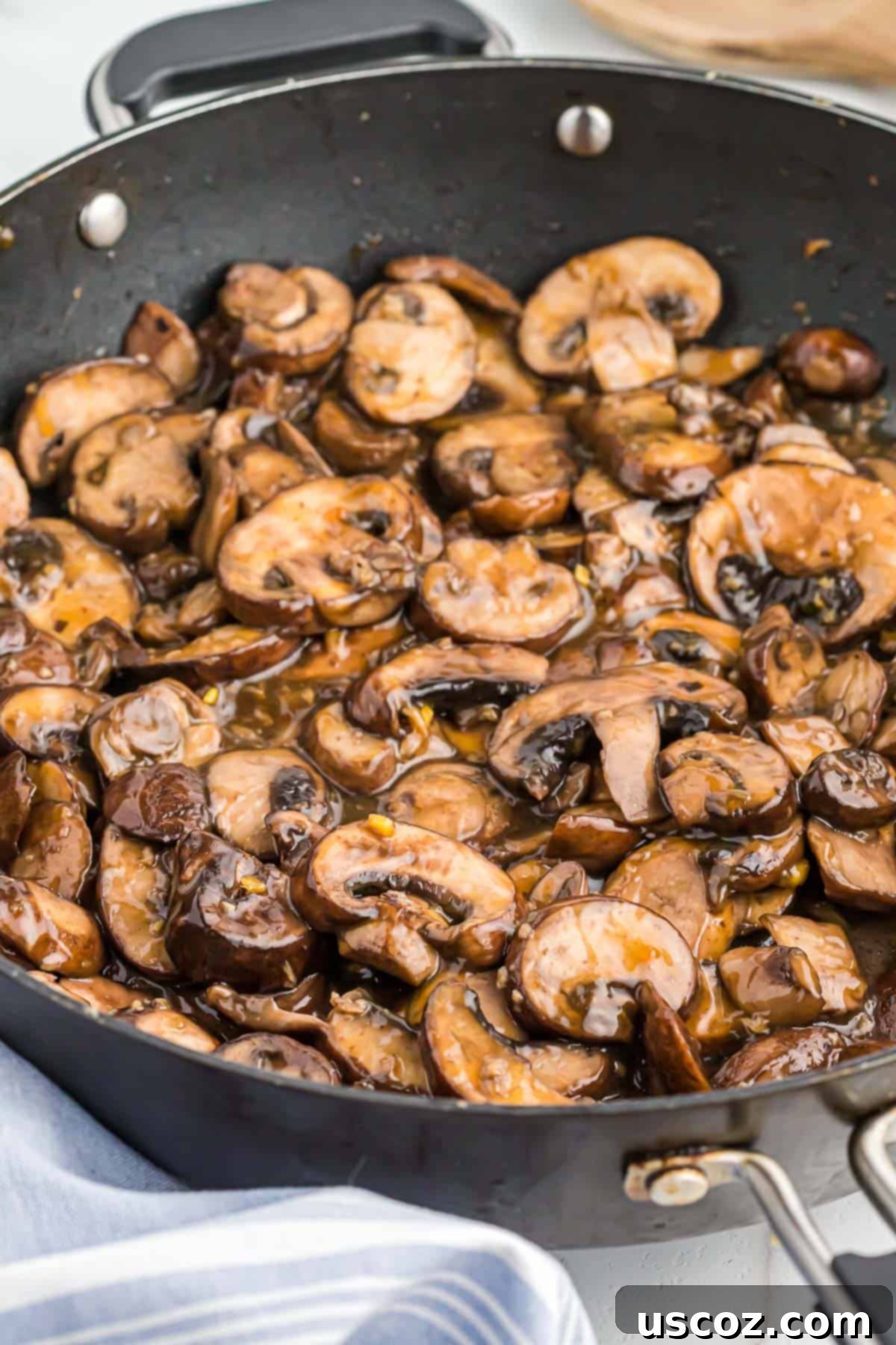 Glazed Teriyaki Mushrooms 10 A large serving of teriyaki fried mushrooms in a skillet, ready for family style dining.