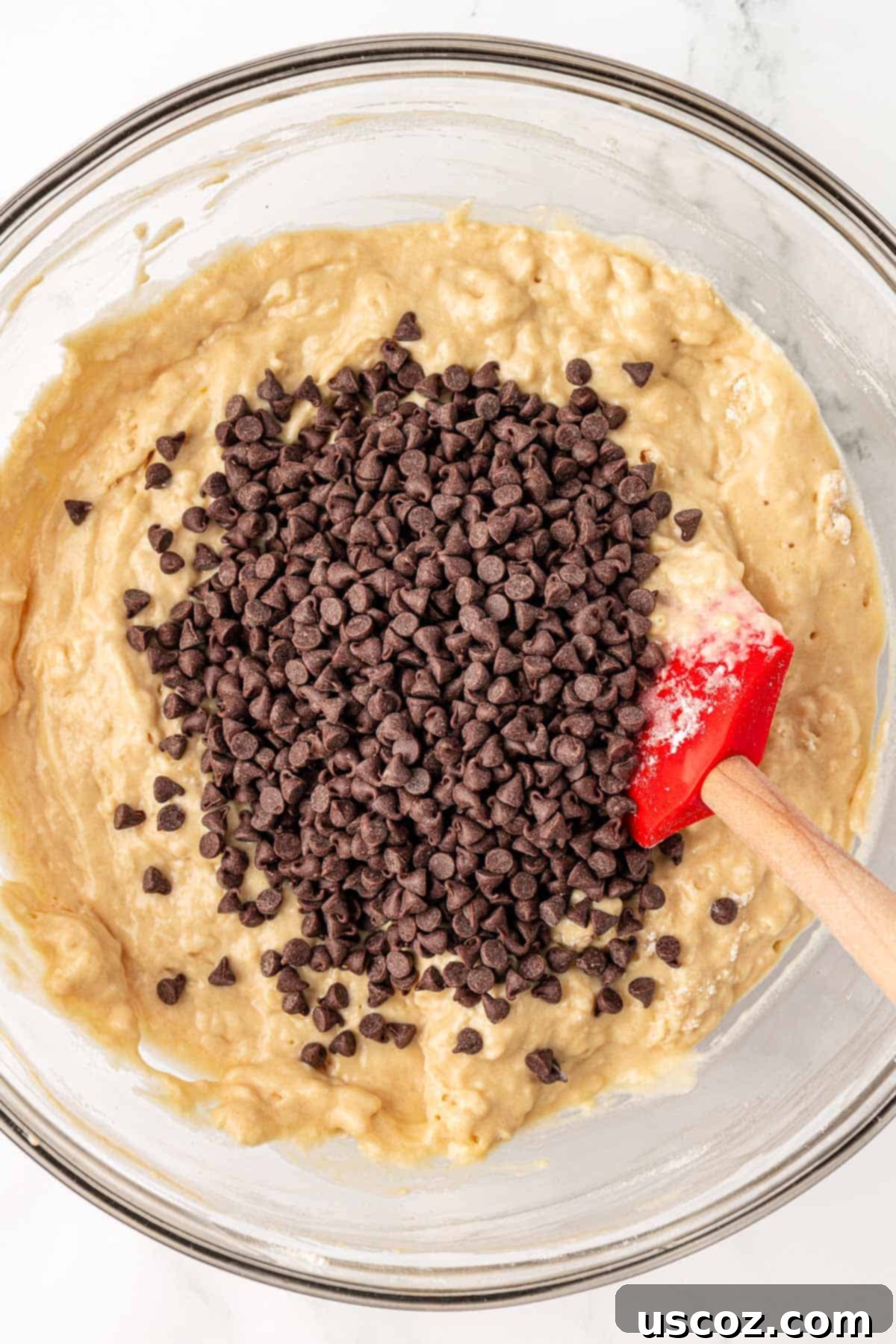 Perfectly Poppable Chocolate Chip Muffins 9 adding the chocolate chips to the batter