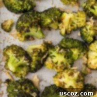 Parmesan Roasted Broccoli 14 Crispy roasted broccoli with parmesan on a sheet pan, ready to serve