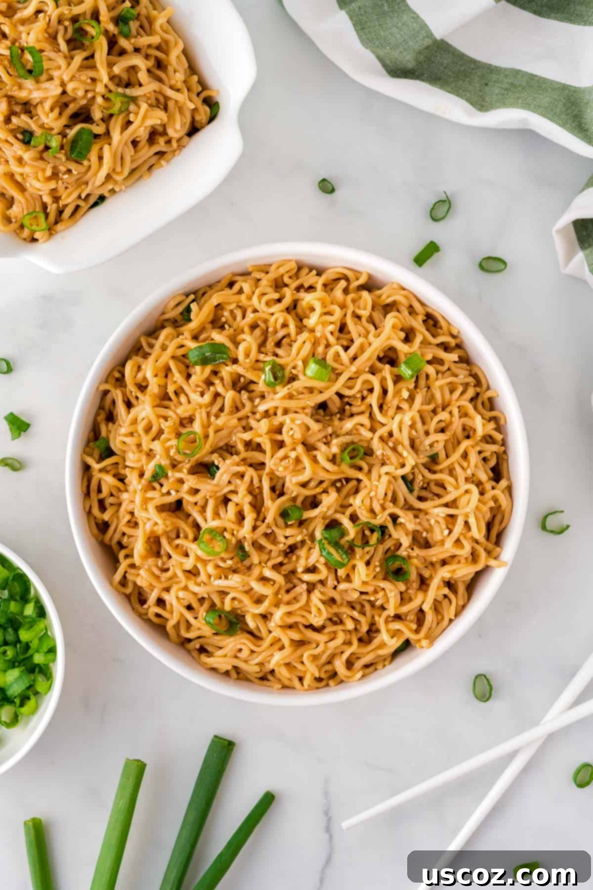 Easy Sesame Garlic Ramen 12 A beautifully presented white bowl of sesame garlic ramen noodles, generously garnished with fresh green onions, inviting a delicious meal.