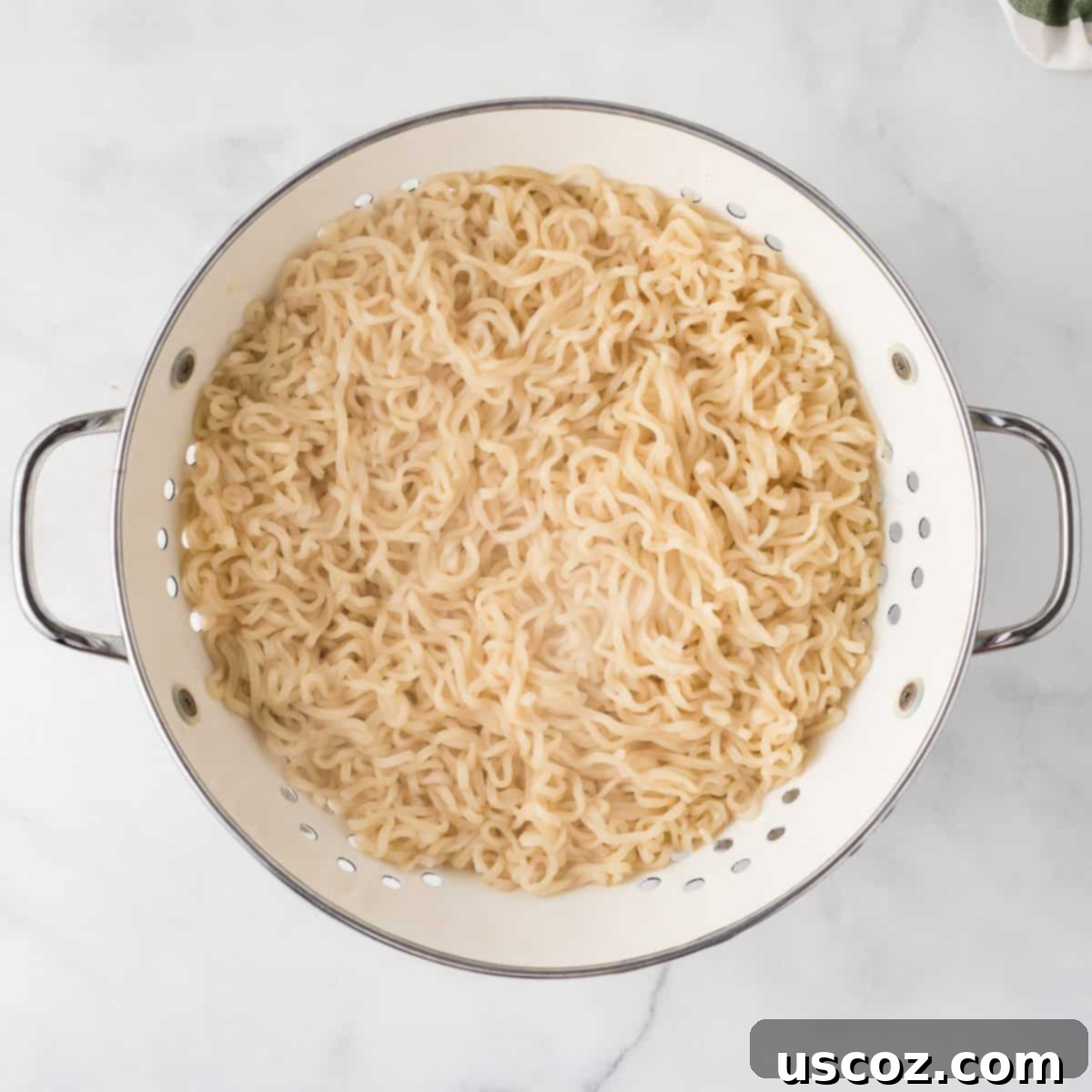 Easy Sesame Garlic Ramen 6 Cooked ramen noodles resting in a metal strainer, perfectly drained and ready to be tossed with the savory sesame garlic sauce.