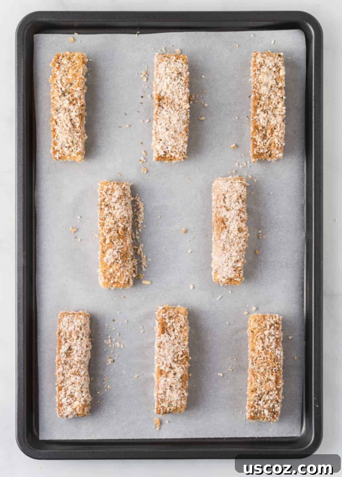 Savory Tofu Wraps 12 breaded tofu strips on a lined baking sheet