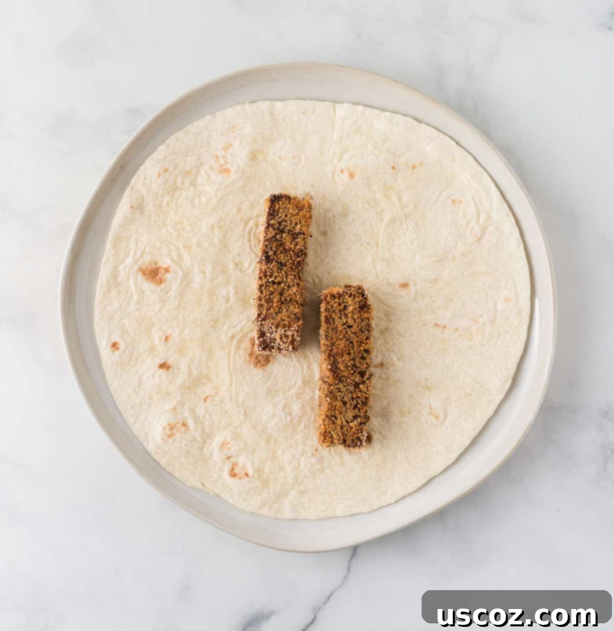 Savory Tofu Wraps 14 a flour tortilla with two tofu strips on it