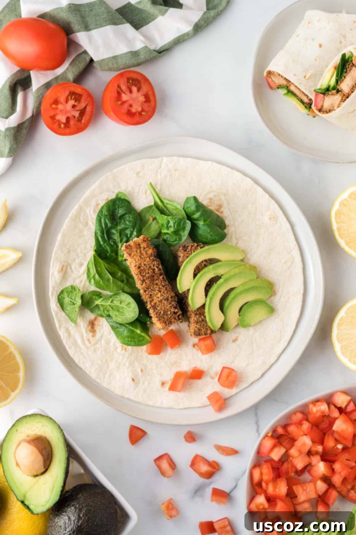 Savory Tofu Wraps 3 tofu wrap open showing the avocado, spinach, tomato, tofu, and lemon
