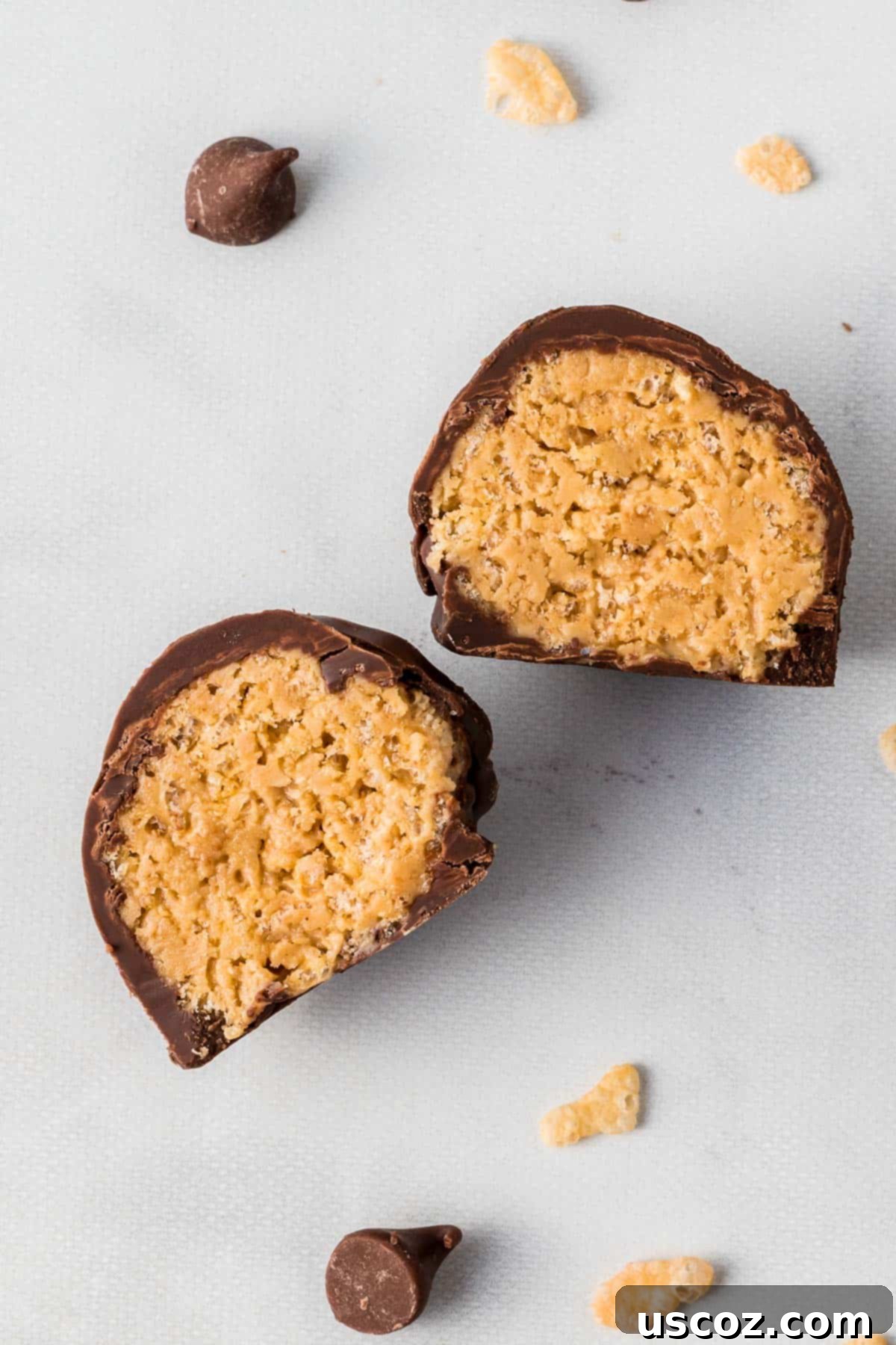No-Bake Peanut Butter Krispie Treats 12 A single peanut butter ball with Rice Krispies, cut open to display its delightful crunchy and creamy filling.