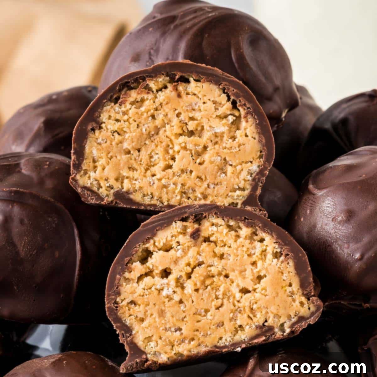 No-Bake Peanut Butter Krispie Treats 13 A festive close-up of several chocolate-dipped peanut butter balls with Rice Krispies, showcasing their appealing texture.