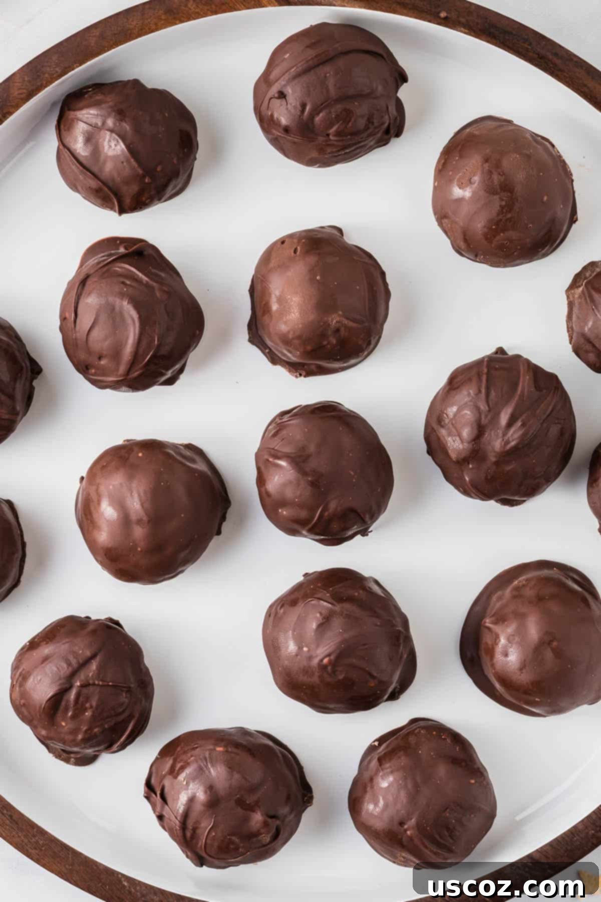 No-Bake Peanut Butter Krispie Treats 3 Assortment of chocolate-dipped peanut butter balls with Rice Krispies on a festive white background.