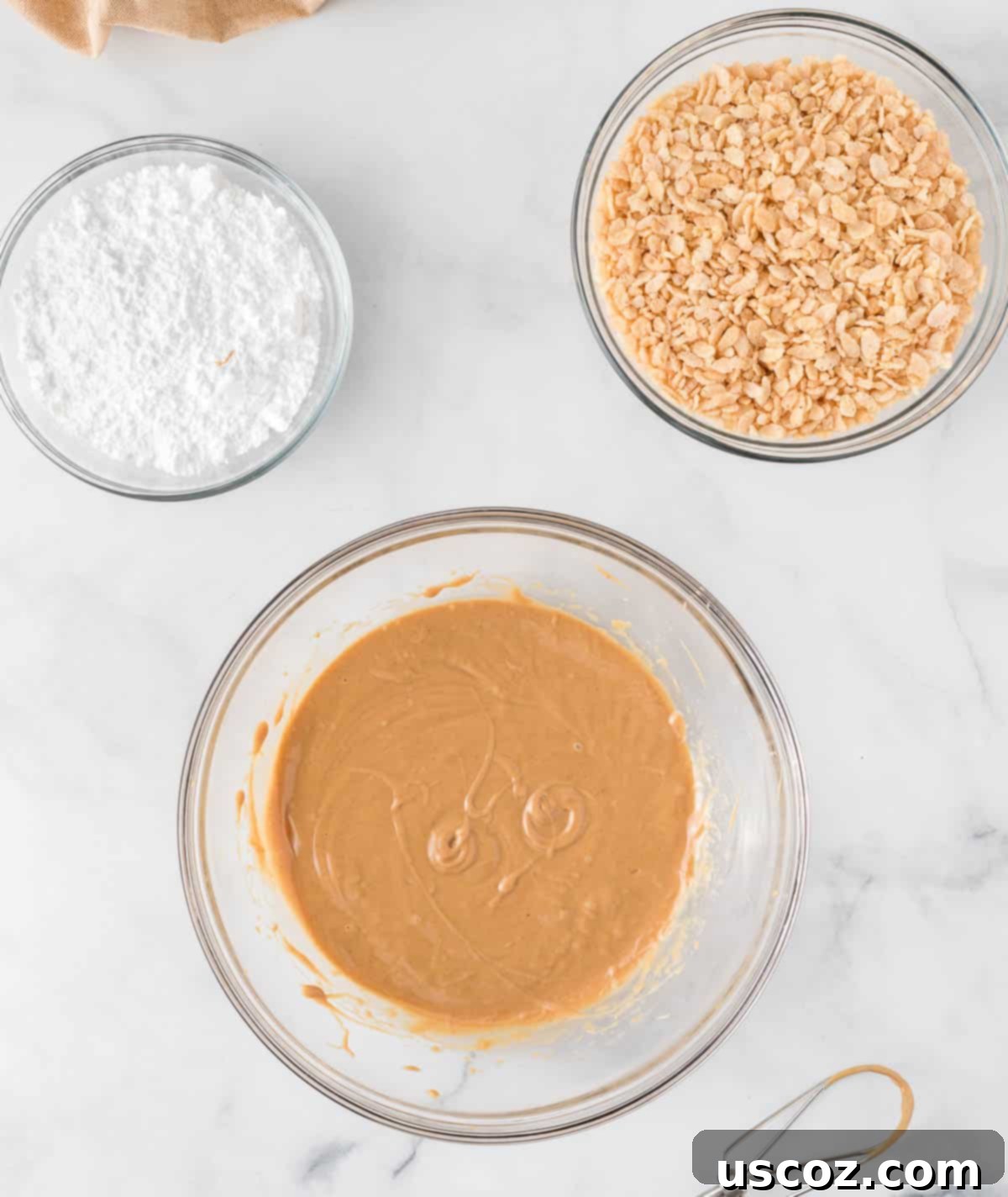 No-Bake Peanut Butter Krispie Treats 5 Three separate bowls containing melted peanut butter, dry Rice Krispies cereal, and powdered sugar, ready for mixing.