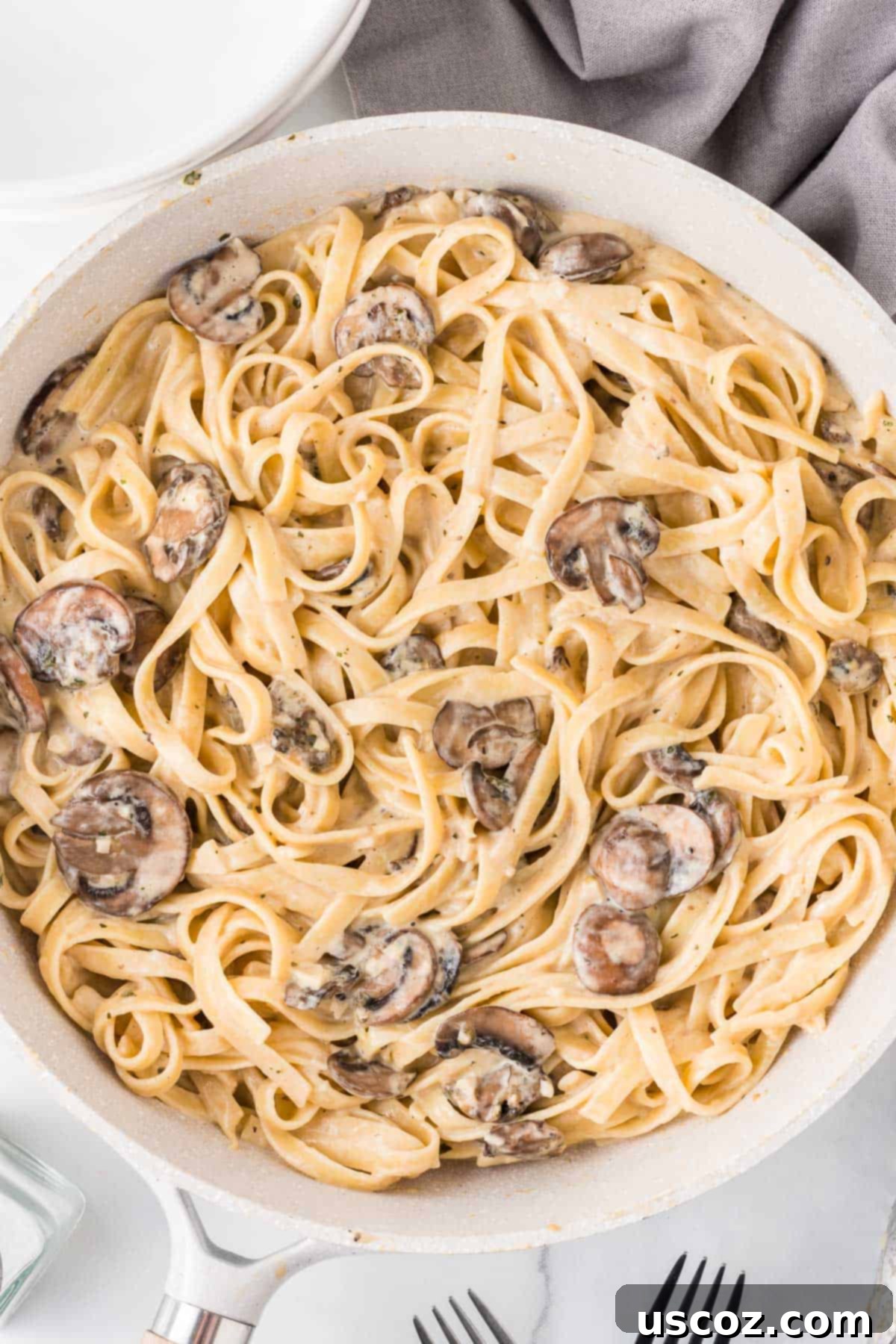 Velvety Mushroom Pasta 2 Creamy mushroom pasta generously served in a rustic skillet, ready to be enjoyed.