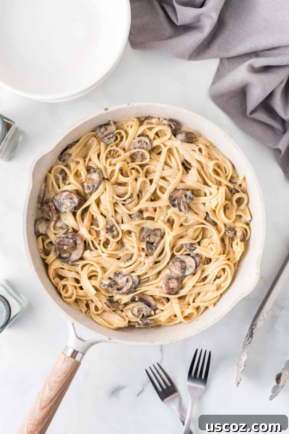 Velvety Mushroom Pasta 10 A generous serving of creamy mushroom pasta in a deep skillet, garnished with fresh herbs, ready for the dinner table.