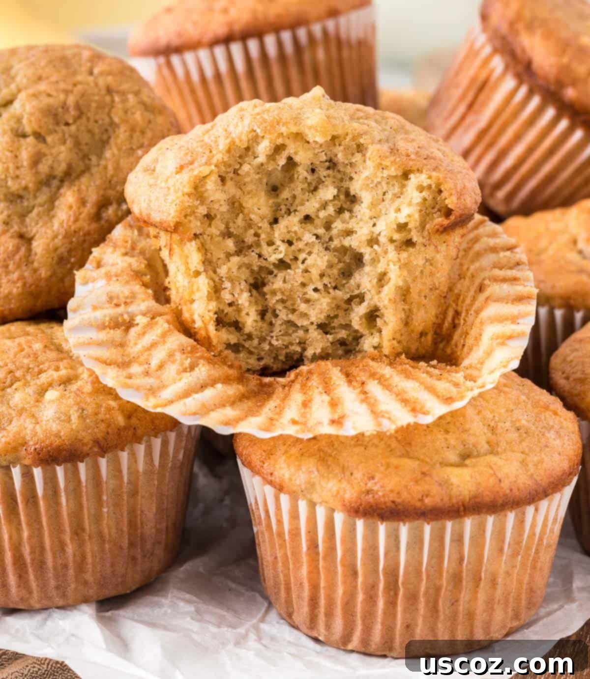 Easy Cake Mix Banana Muffins 12 A delicious cake mix banana muffin with a bite taken out, revealing its moist and tender interior.