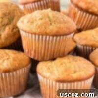 Easy Cake Mix Banana Muffins 16 Close-up of fluffy cake mix banana muffins stacked, highlighting their perfect golden crust and inviting texture.