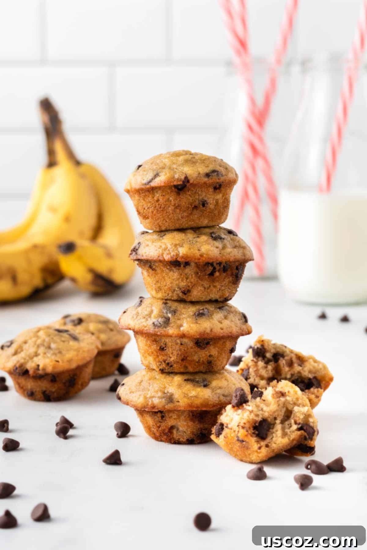 Bite-Sized Banana Muffins 2 Stacked mini chocolate chip banana muffins on a wooden board
