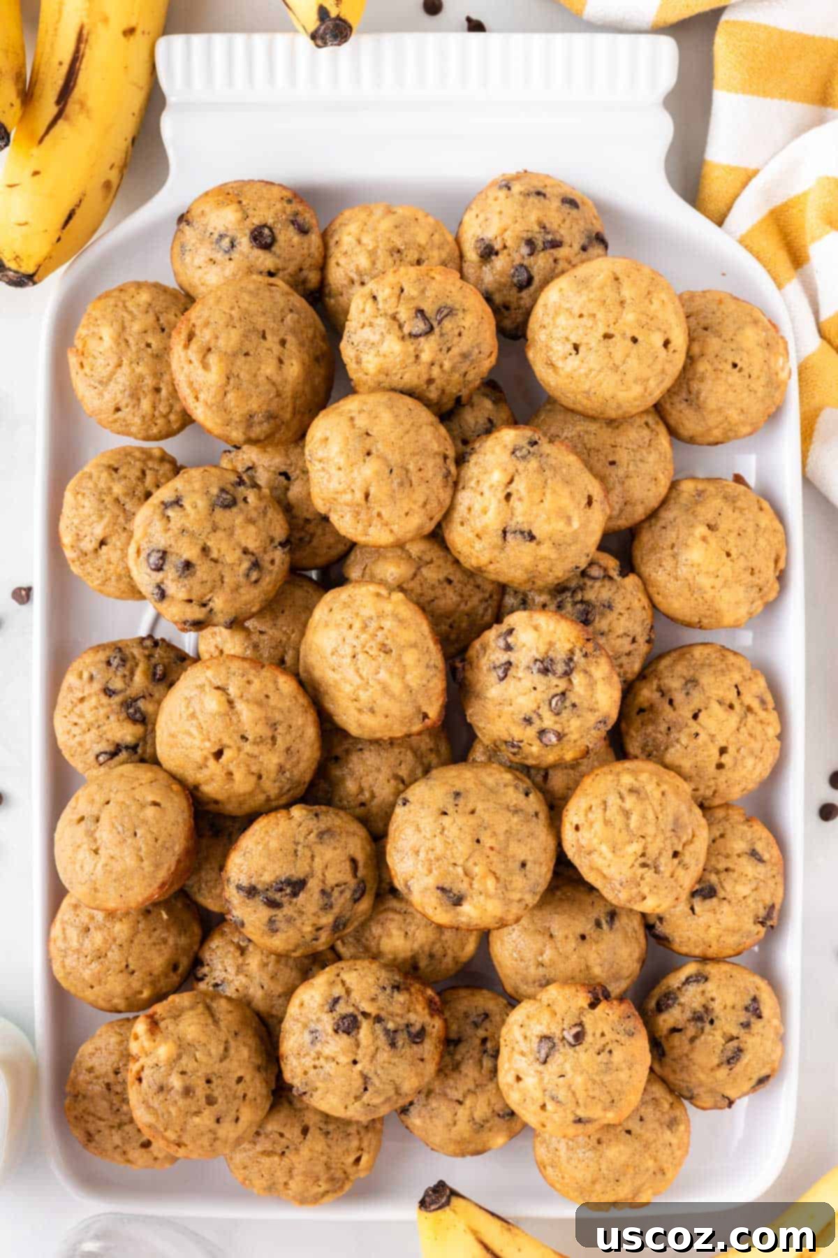 Bite-Sized Banana Muffins 14 A cluster of mini banana muffins on a pristine white platter, ready for serving