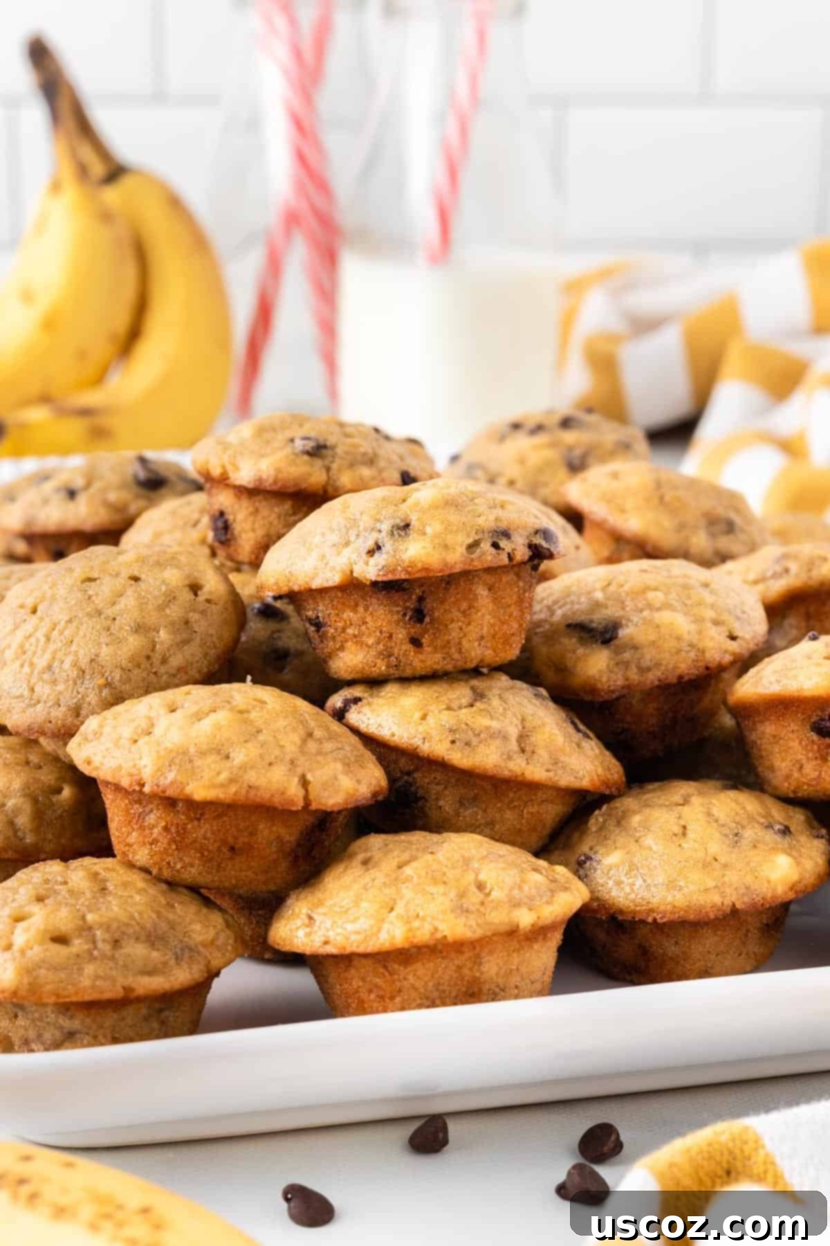 Bite-Sized Banana Muffins 3 A selection of plain mini banana muffins arranged on a white serving platter