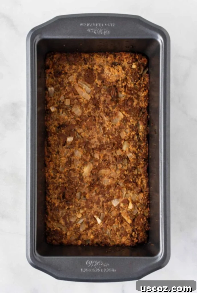Hearty Plant-Based Meatloaf 11 Side view of vegetarian meatloaf shaped in a loaf pan, showing its even and compact form
