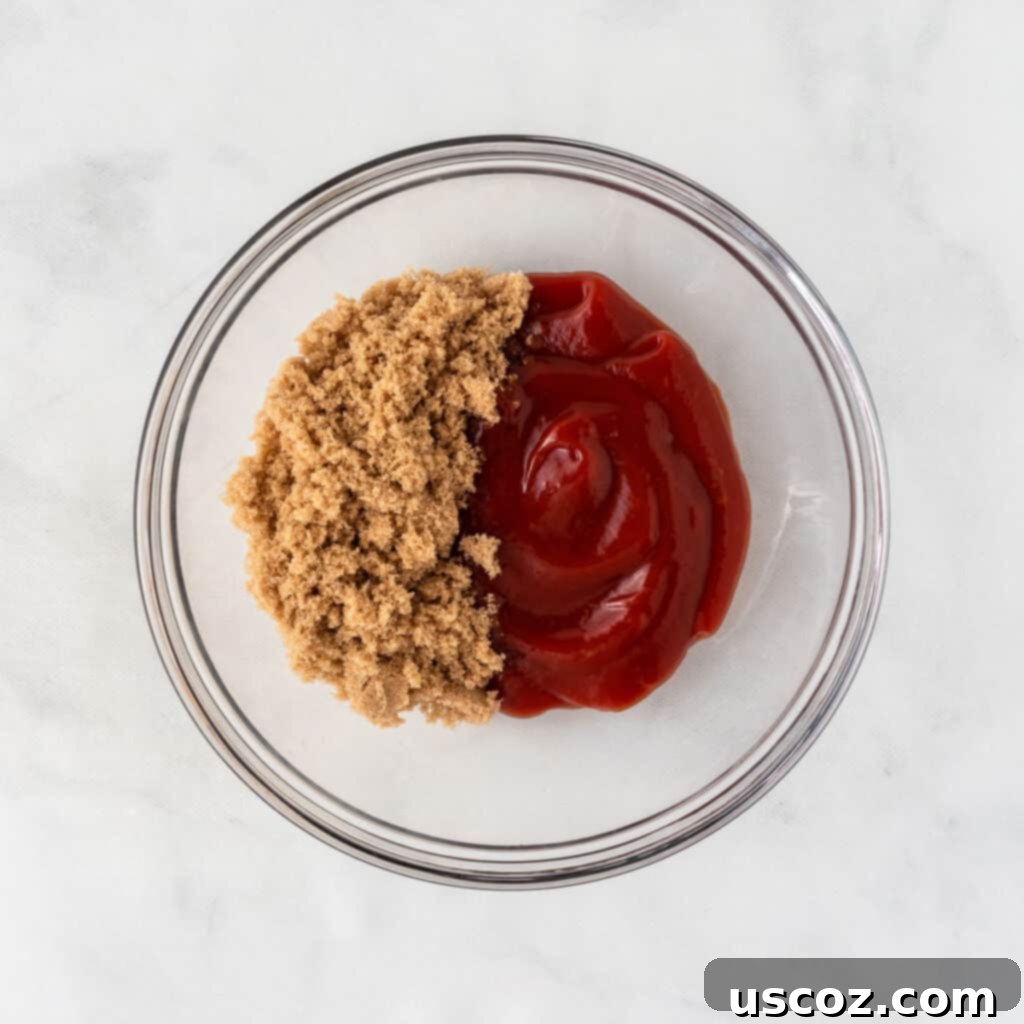 Hearty Plant-Based Meatloaf 12 Brown sugar and ketchup being combined in a small bowl with a spoon, creating the meatloaf glaze