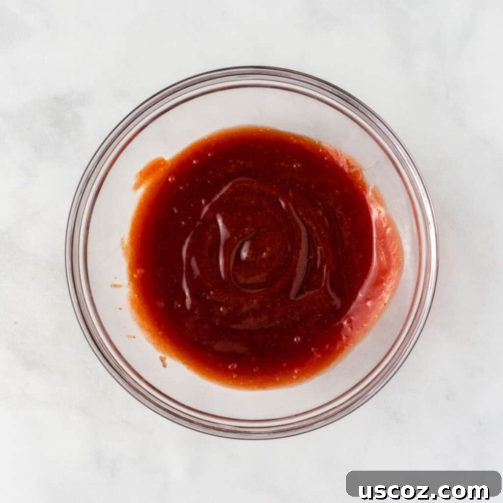 Hearty Plant-Based Meatloaf 13 A bowl of smooth, glossy brown sugar and ketchup glaze, ready for application on the meatloaf
