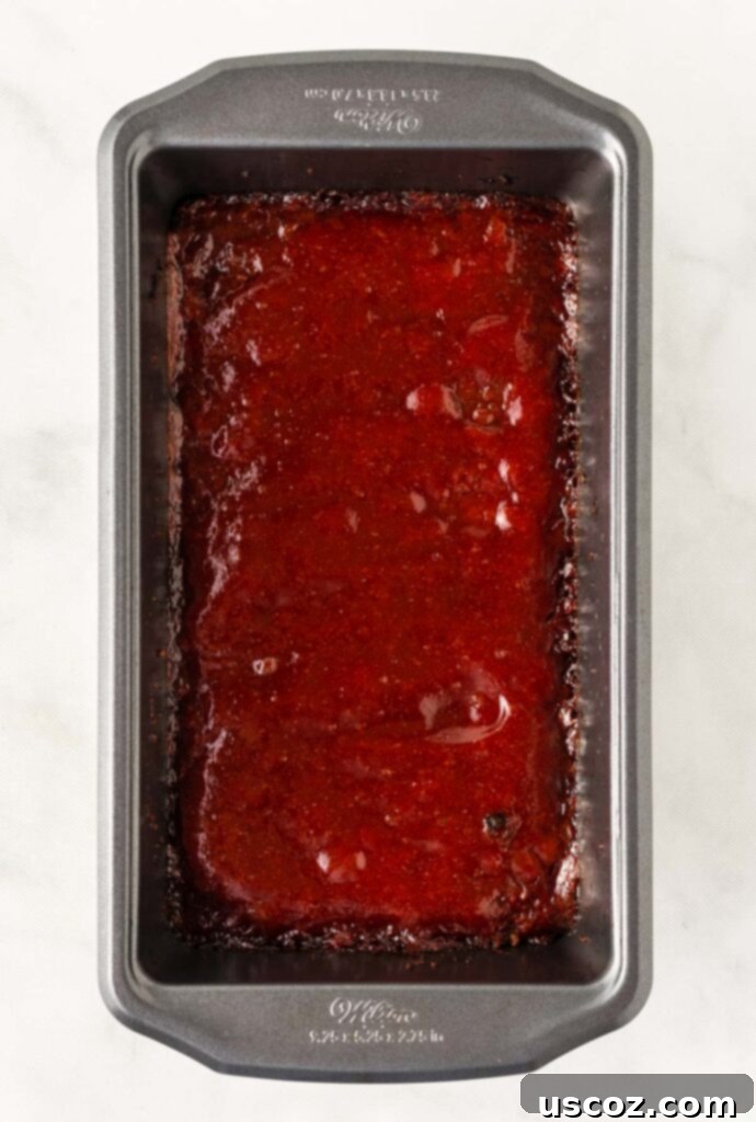 Hearty Plant-Based Meatloaf 15 Finished vegetarian meatloaf in a loaf pan, perfectly glazed and browned with bubbly edges, fresh out of the oven