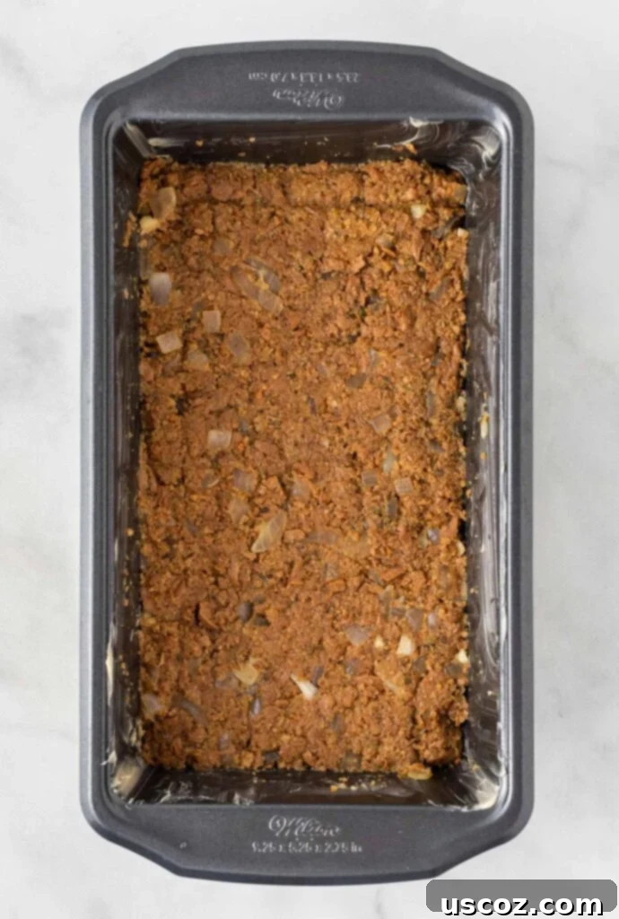 Hearty Plant-Based Meatloaf 10 Vegetarian meatloaf mixture firmly pressed into a greased loaf pan, ready for the oven