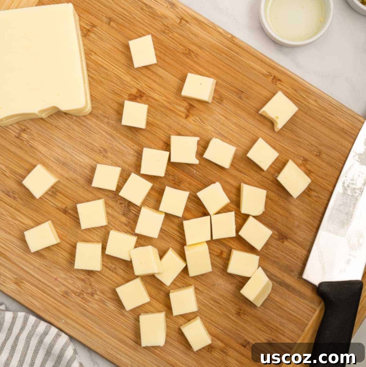 Simple Fresh White Cheese 3 cutting american cheese into blocks on a cutting board