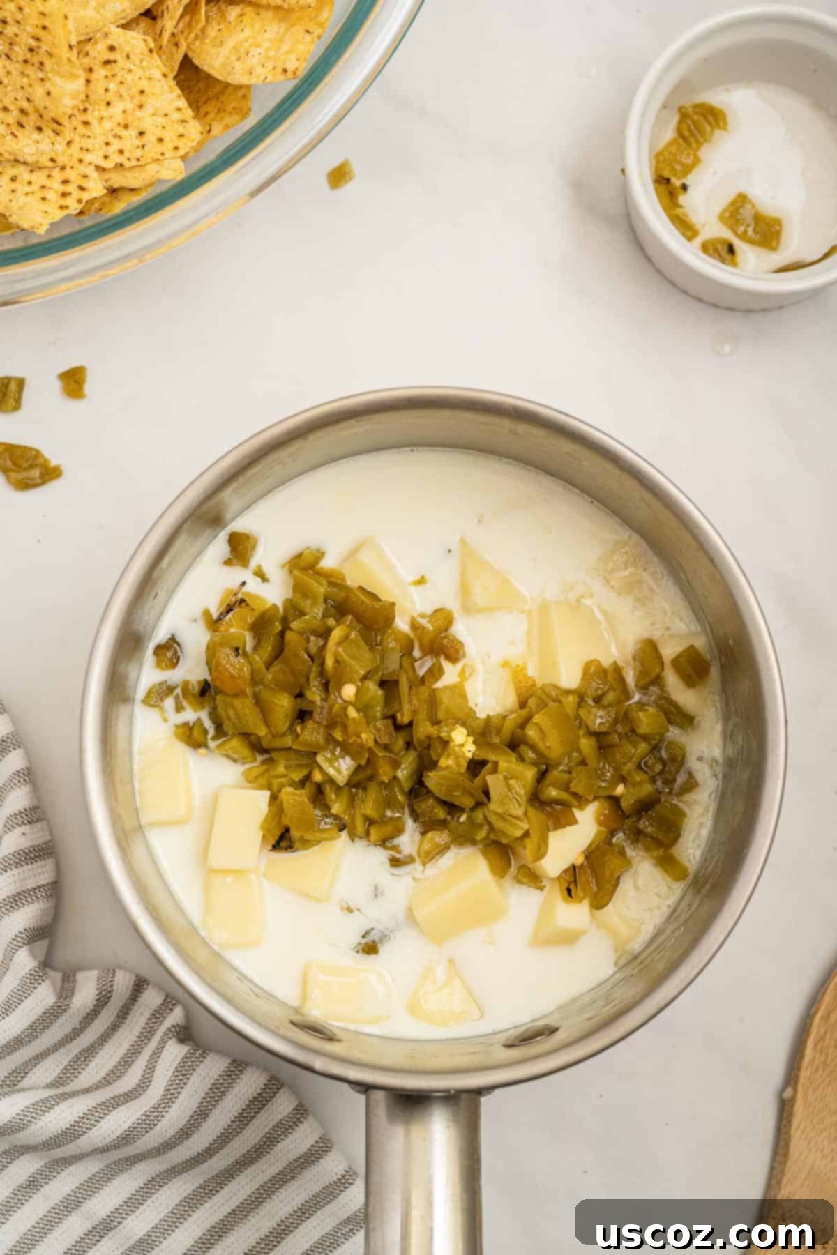 Simple Fresh White Cheese 5 adding milk and jalapeno peppers to the american cheese