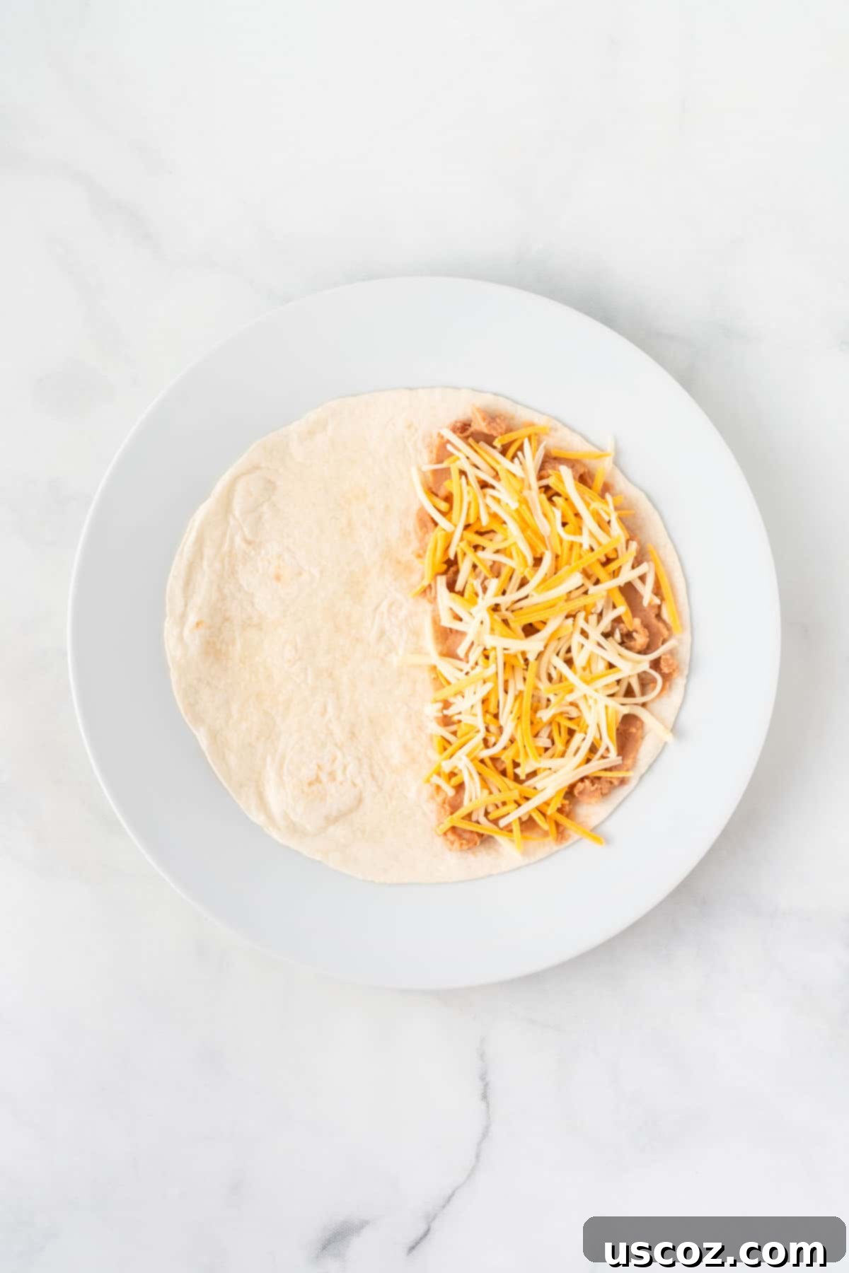 Air Fryer Quesadilla Perfection 5 soft taco shell half spread with refried beans and mexican cheese