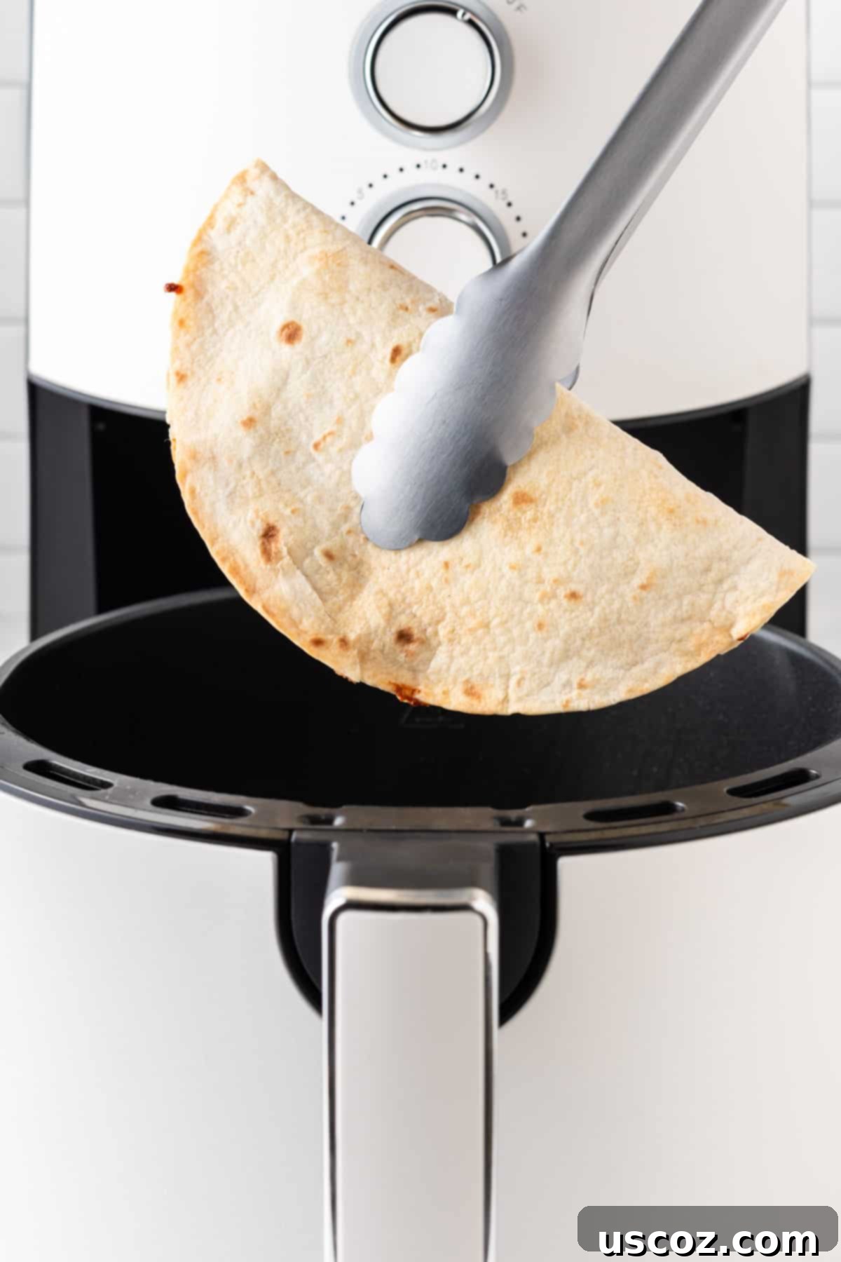 Air Fryer Quesadilla Perfection 8 tongs removing the quesadilla from the air fryer