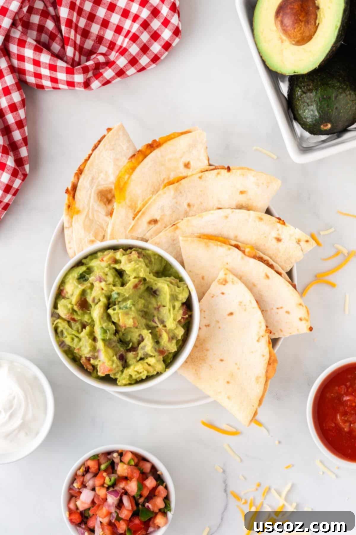 Air Fryer Quesadilla Perfection 9 air fryer quesadillas next to guacamole on a plate