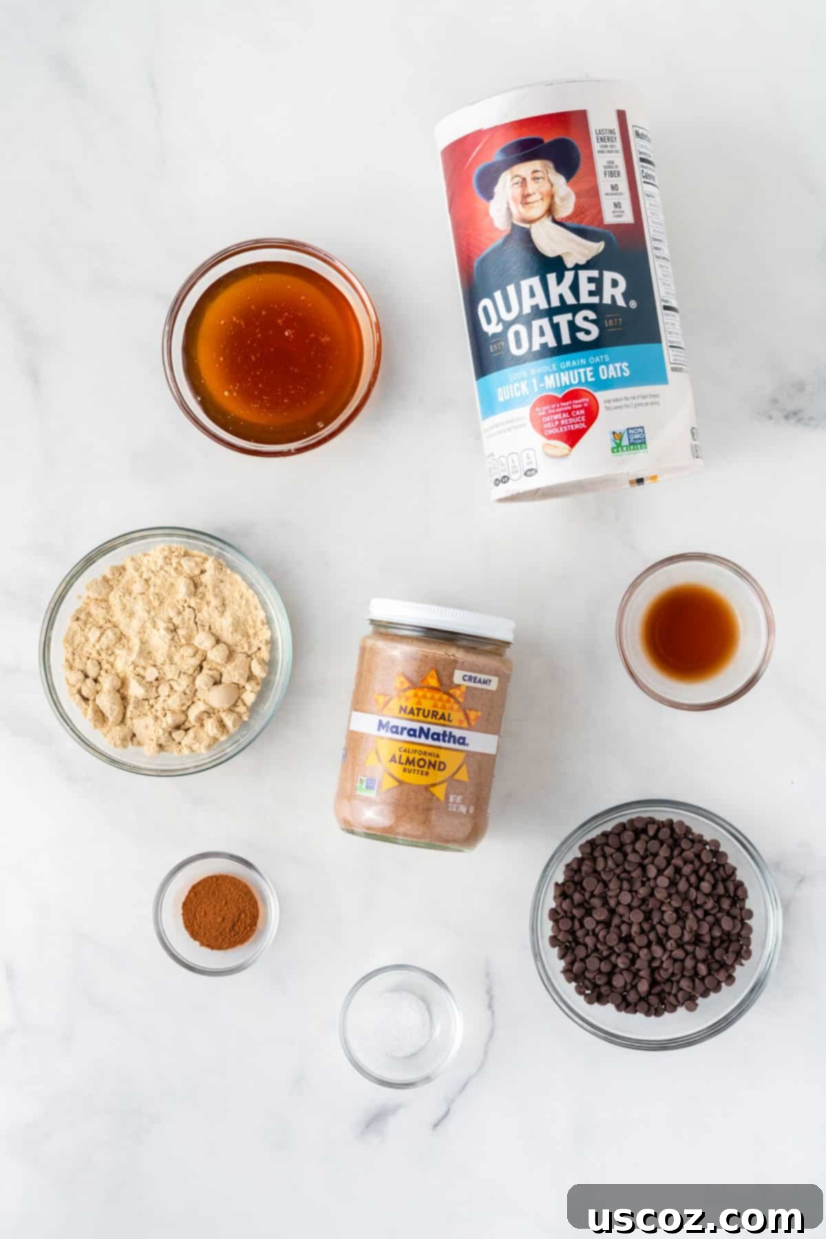 Almond Butter Power Bites 4 ingredients needed to make almond butter energy balls laid out on a surface