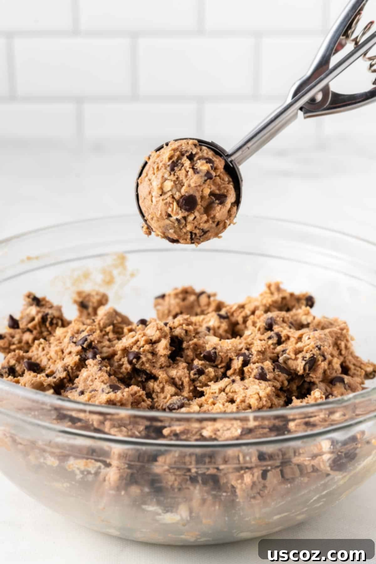 Almond Butter Power Bites 6 mini cookie scoop holding a scoop of energy ball batter
