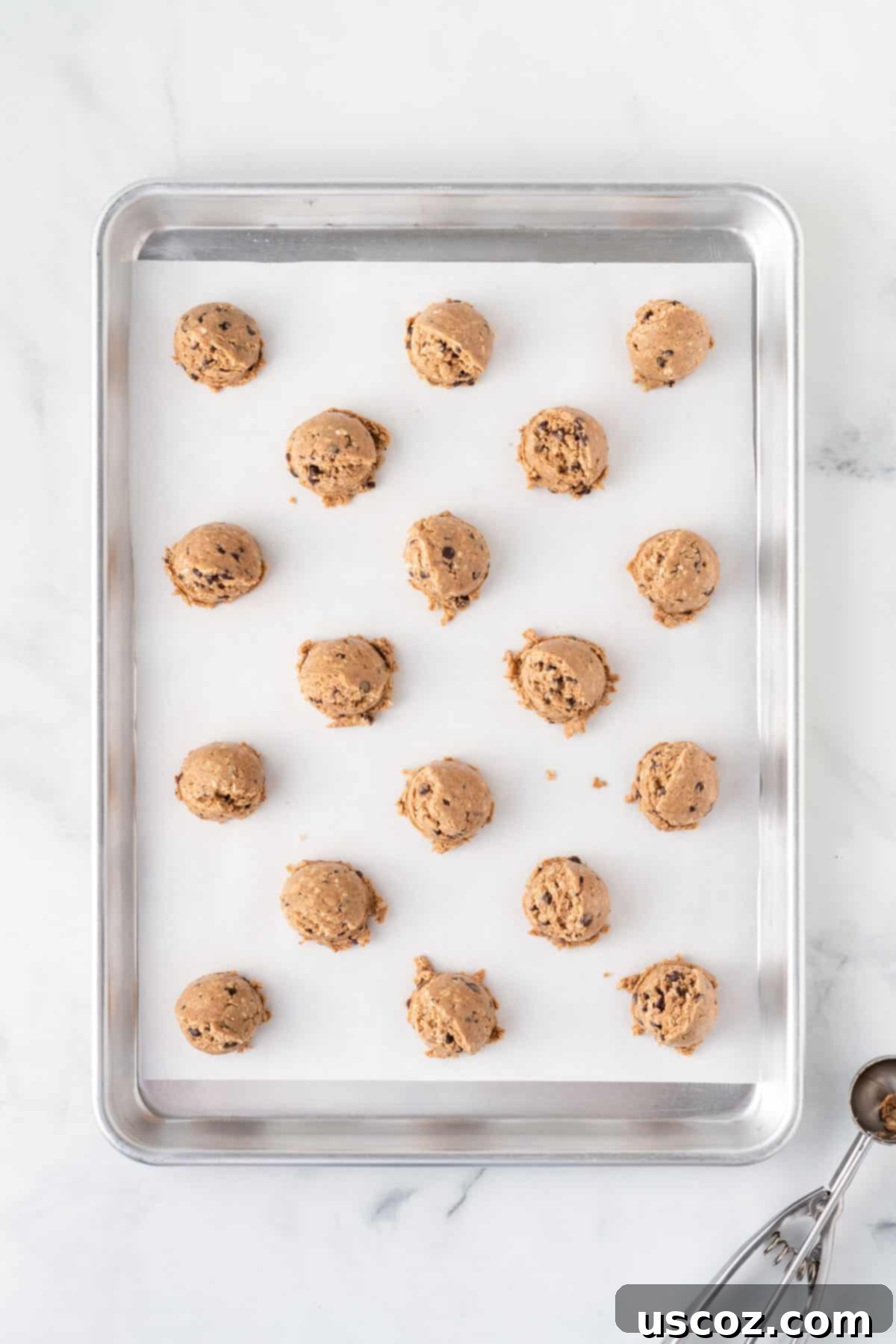 Almond Butter Power Bites 7 scoops of energy ball batter on a lined baking sheet