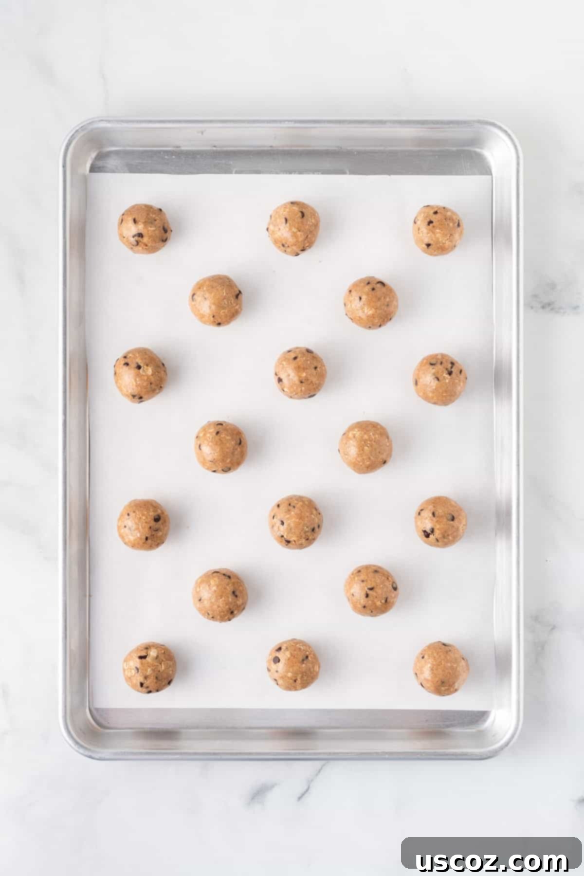 Almond Butter Power Bites 8 almond butter energy balls on a baking sheet, after chilling