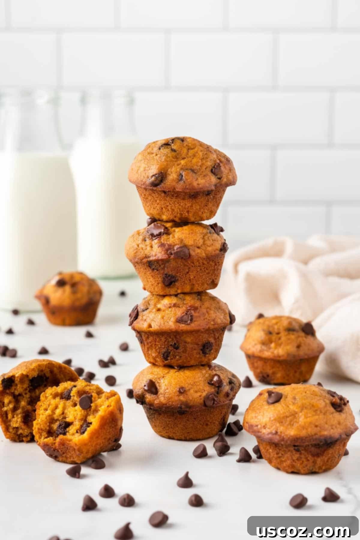Bite-Sized Pumpkin Delights 3 Close-up stack of perfectly baked mini pumpkin muffins, showcasing their fluffy texture.